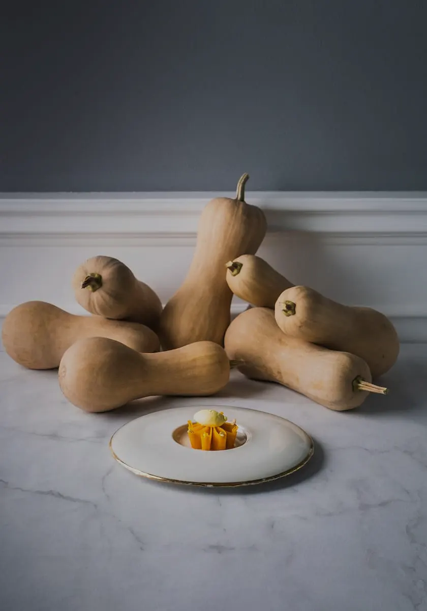 A gourmet dish next to some pumpkins at a Fine Dining Restaurant in Ubud