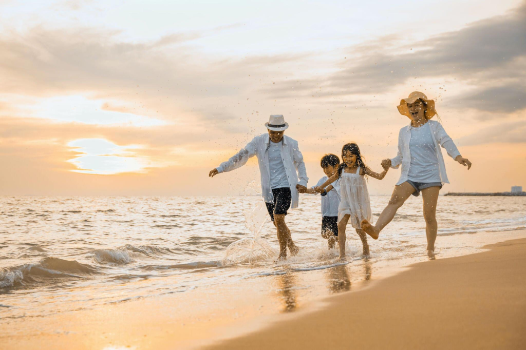 A family walking on a beach in Kuta, Bali