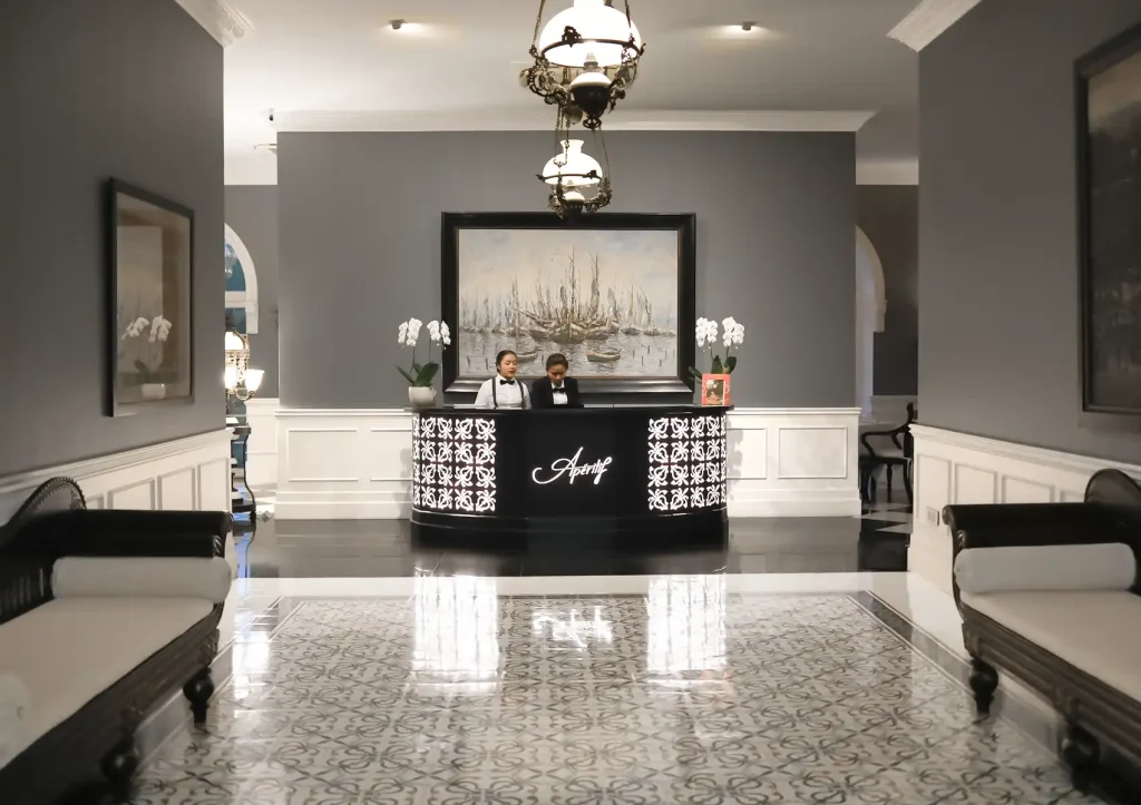 Fine dining reception at Bali restaurant with elegant décor, formal staff, and luxurious ambiance.